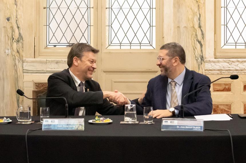 Oscar Alpa y Juan Manuel Olmos al firmar el convenio